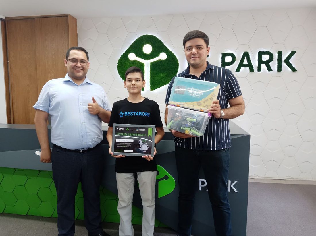 Asadbek in a BESTARORG shirt receiving 2nd place at IT Park MITC robotics contest